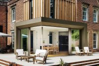 Traditional British Brick House Gains Modern Timber Extensions