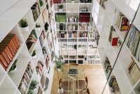Double-Height Living Room and Bookshelves Transform Madrid Home