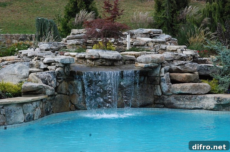 Custom large scale swimming pool with a natural waterfall feature