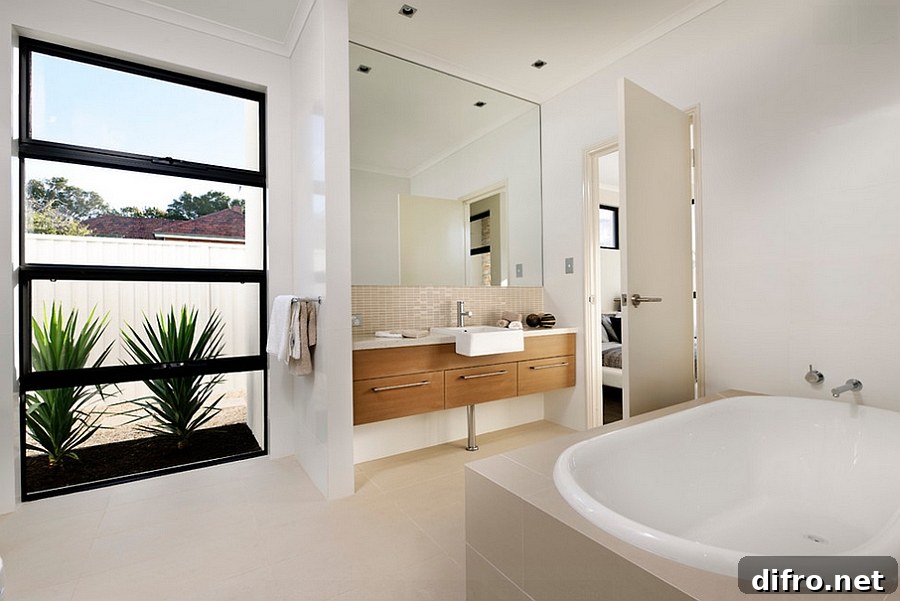 Wooden vanity and natural greenery give the bath a relaxing, trendy look