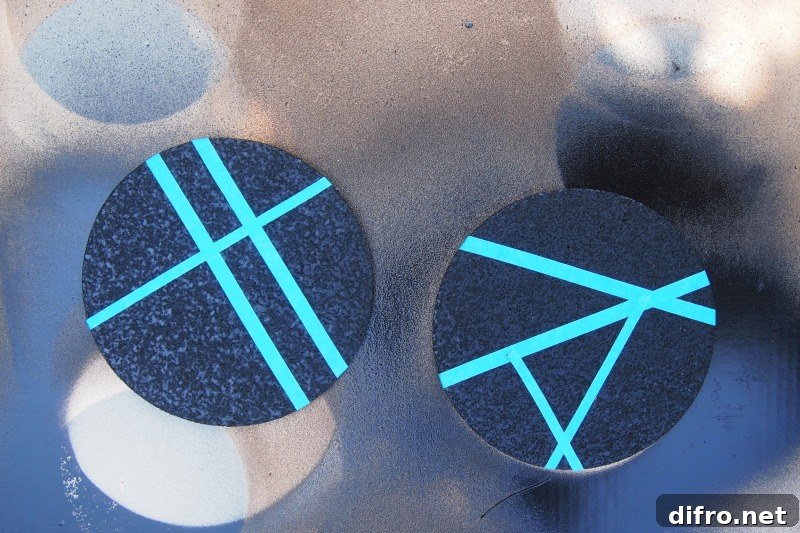 Tape a pattern onto painted coasters