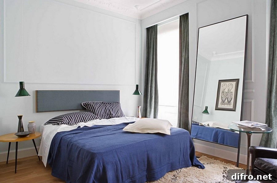 Masculine bedroom with understated bedside lighting and a midcentury style