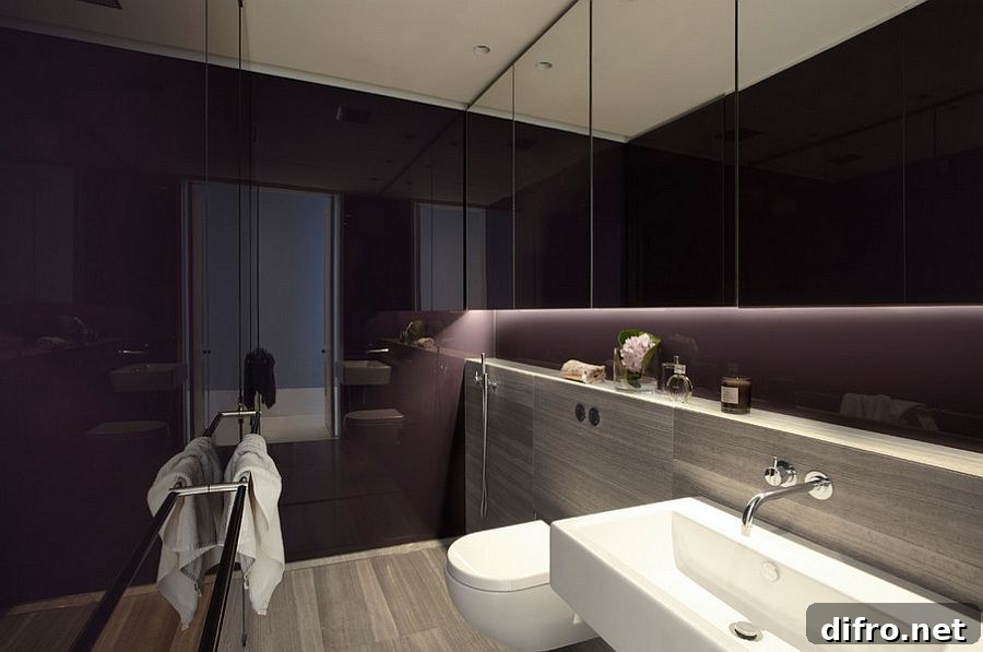 Lighting steals the show in this dark, purple bathroom [Design: Smart Design Studio]
