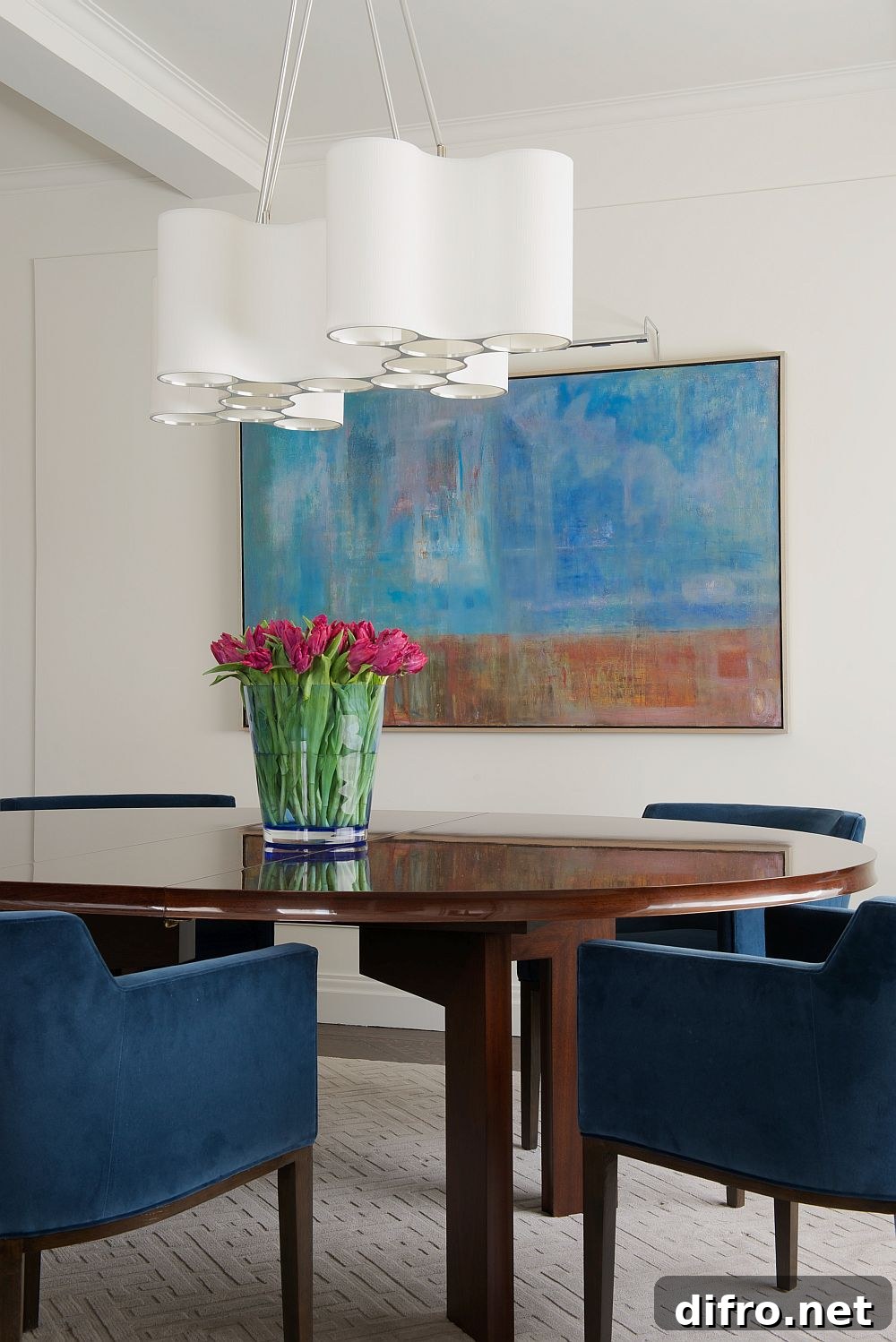 Wall art complements the color scheme of the dining room