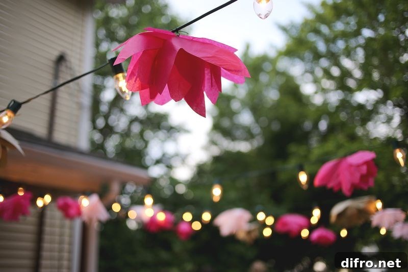 Tissue paper flowers embellish a string of outdoor lights