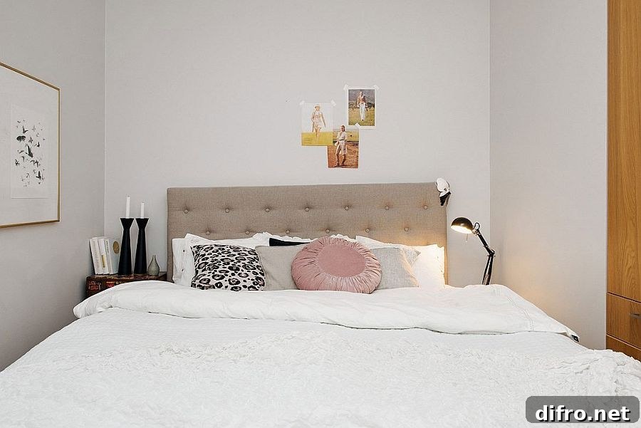Tiny bedroom in white with small beside tables and floor lamp