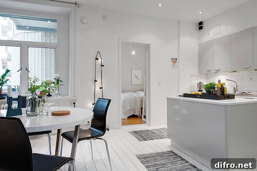 All-white kitchen and dining area of the Scandinavian home