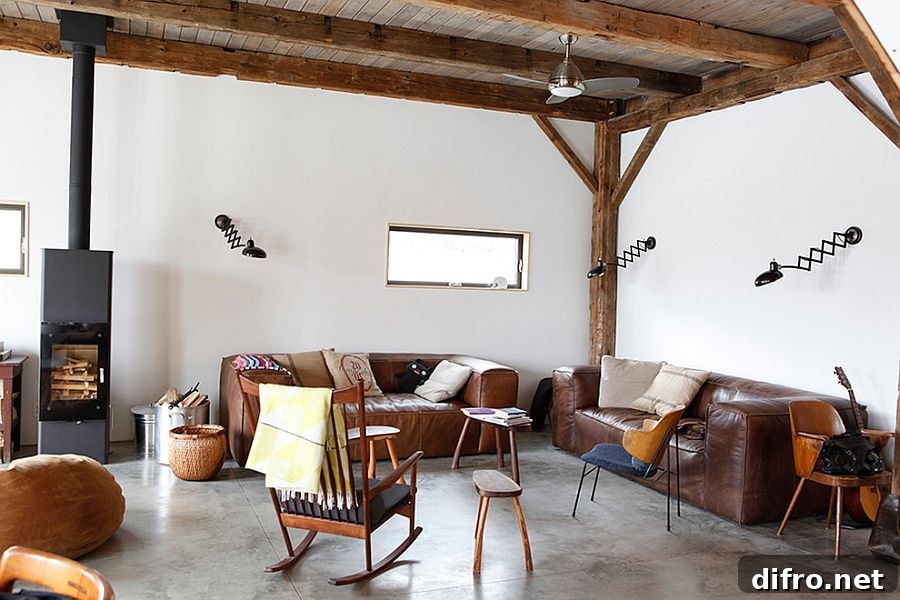 Elegant leather sofas and sconce lighting for the rustic living space