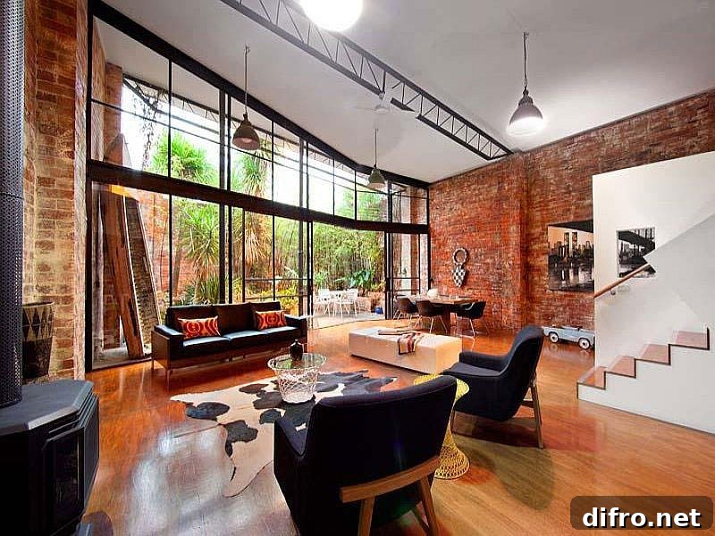 Living room of converted warehouse in Melbourne with brick walls and large glass wall