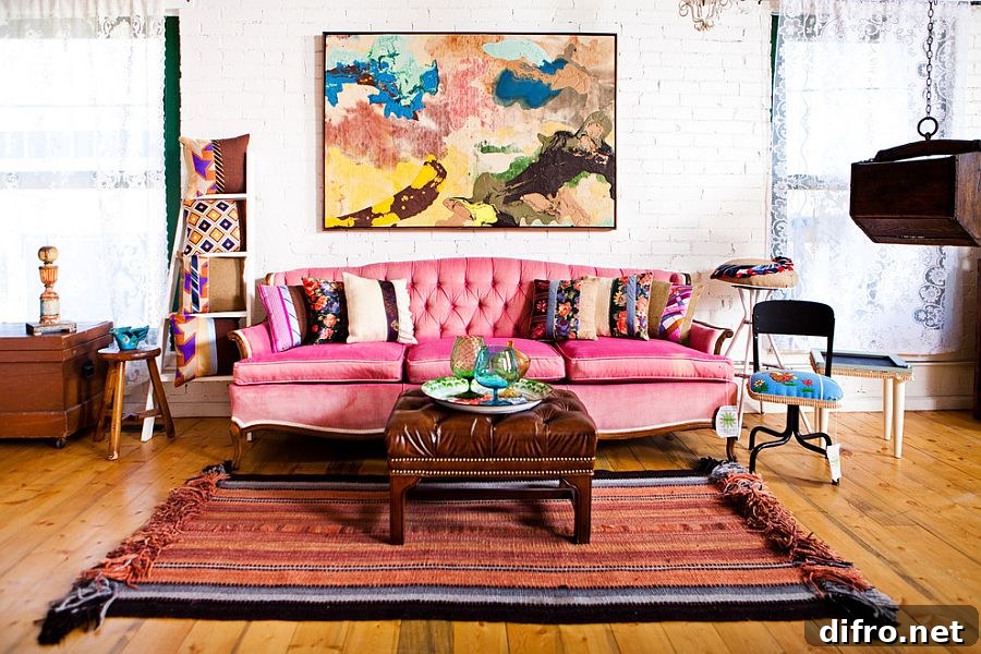 Colorful couch in pink and lovely wall art for the shabby chic living space [Design: Vintage Renewal]