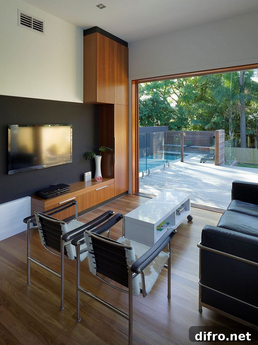 Living area of the modest family home in Australia overlooking the pool and deck