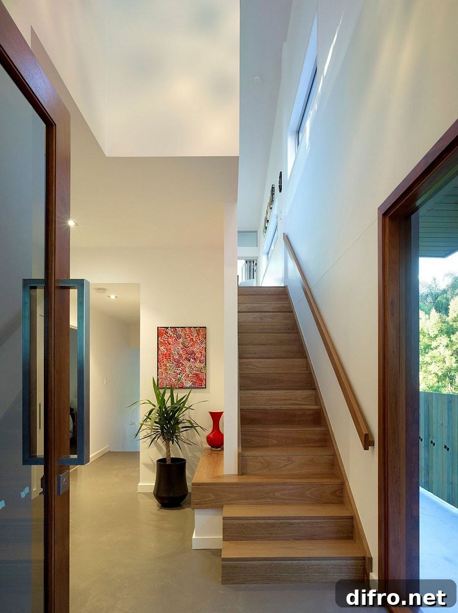 Staircase leading to the top level with bedrooms and additional living area