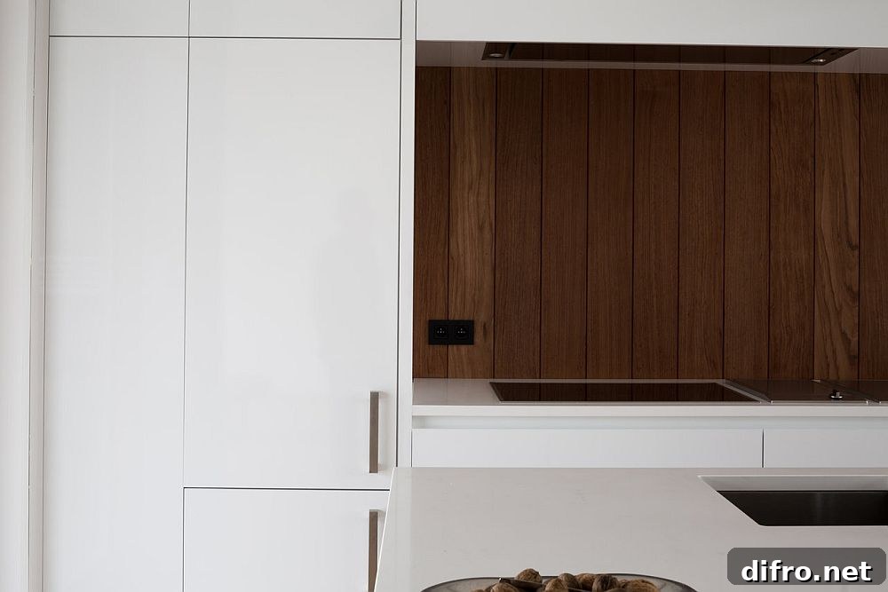Modern kitchen in white with wooden backsplash