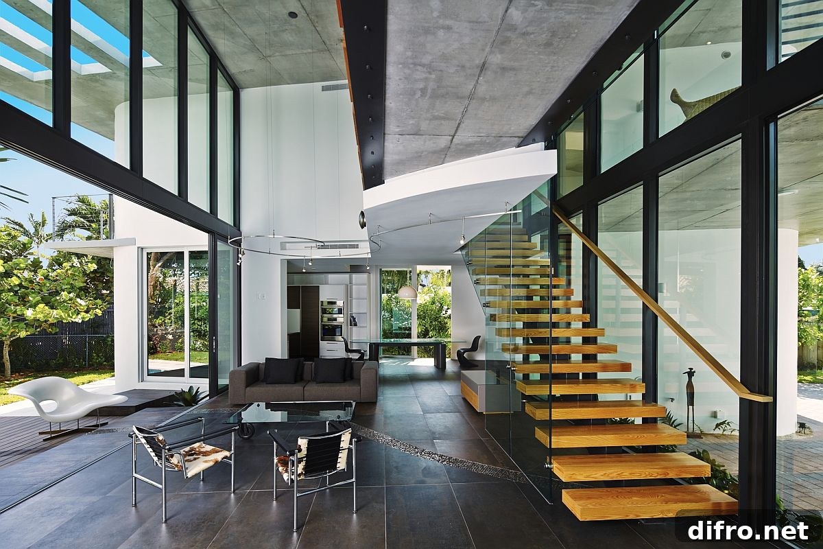 Exquisite living area with glass walls and floating staircase