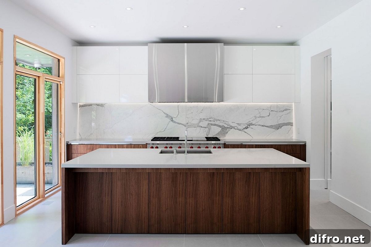 Contemporary kitchen in white with wooden lower cabinets, island and a marble backsplash