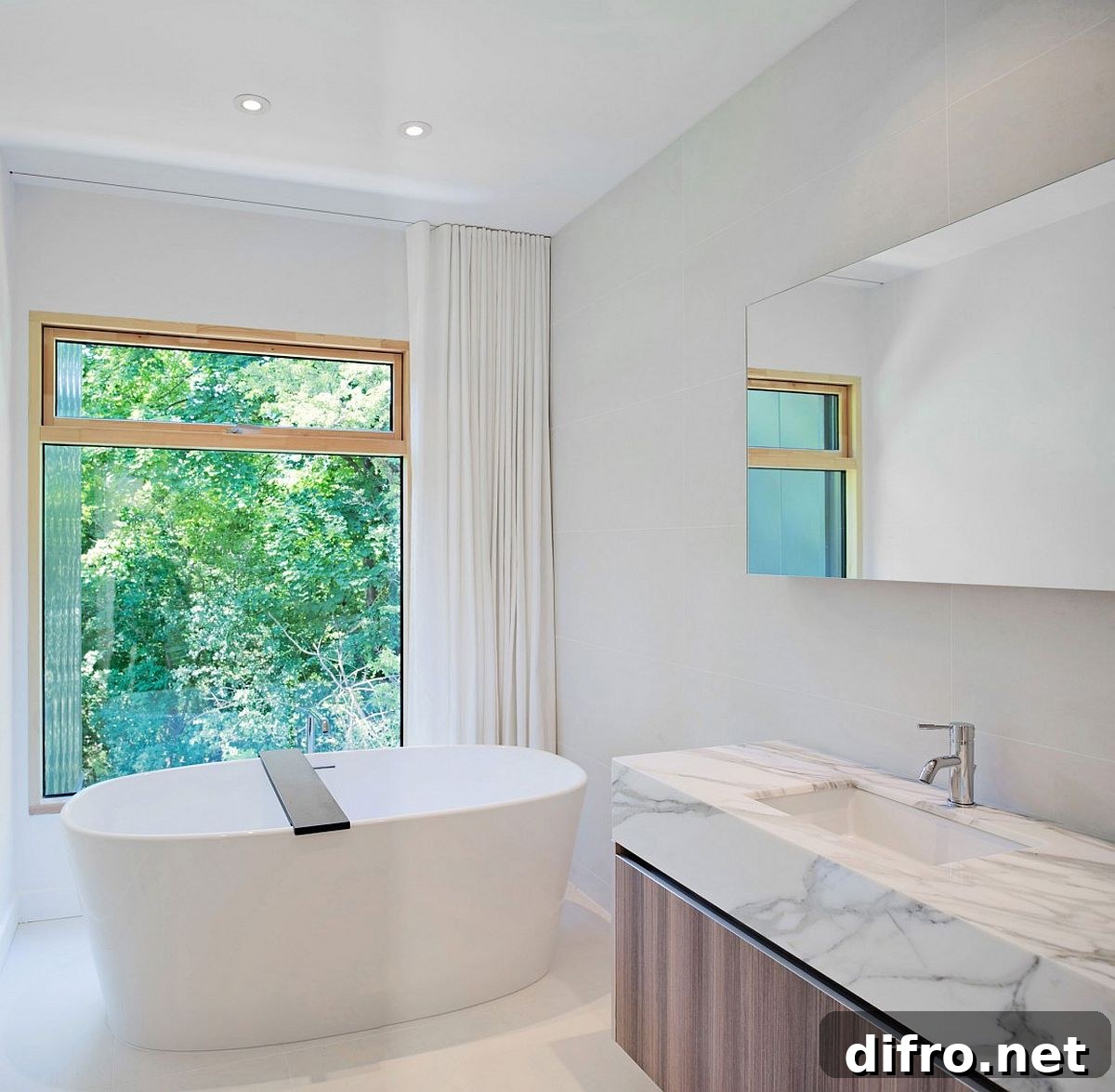 Standalone bathtub and vanity with wooden base and marble top inside the contemporary bathroom