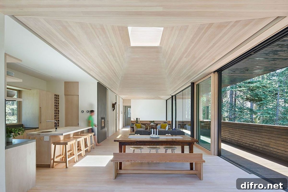 Open plan living of the cozy cabin with kitchen and dining
