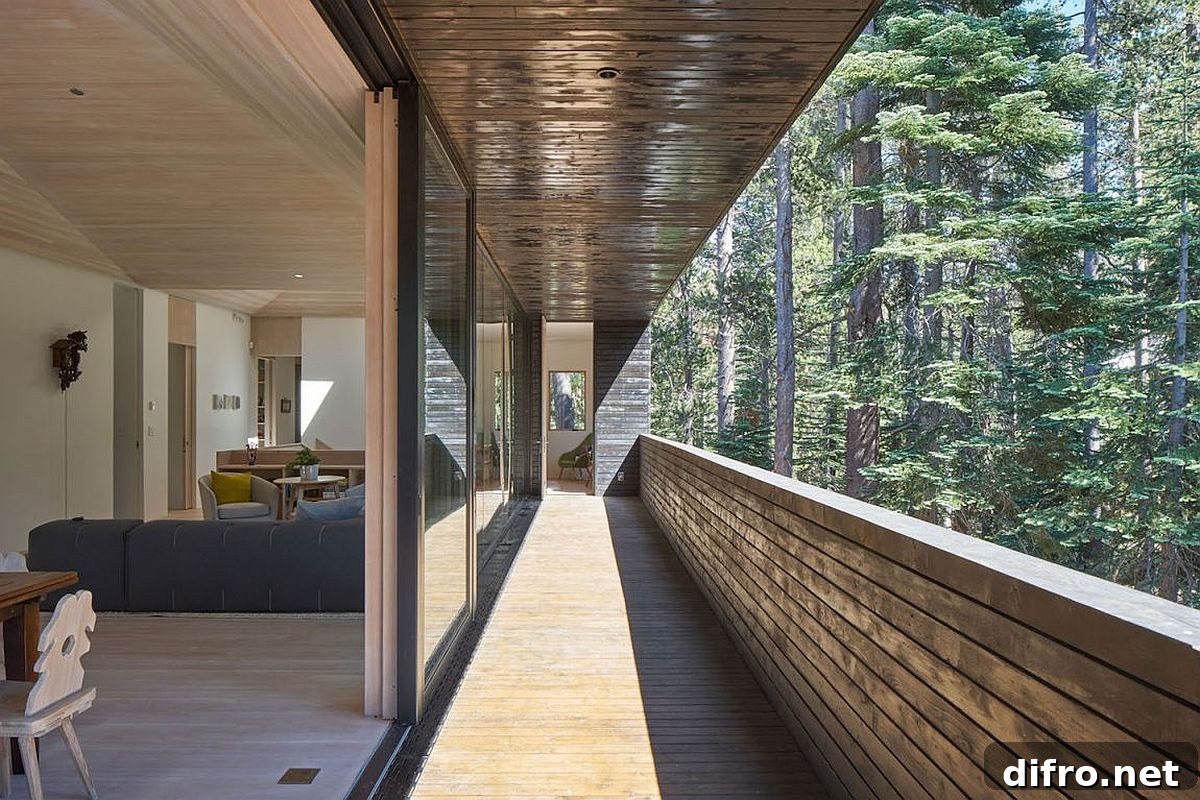 Long open balcony of the beautiful cabin offers lovely views and brings sunlight indoors