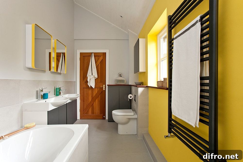 Contemporary bathroom in yellow and gray with ample natural light [Design: InStil Design Limited / Photo: Fraser Marr]