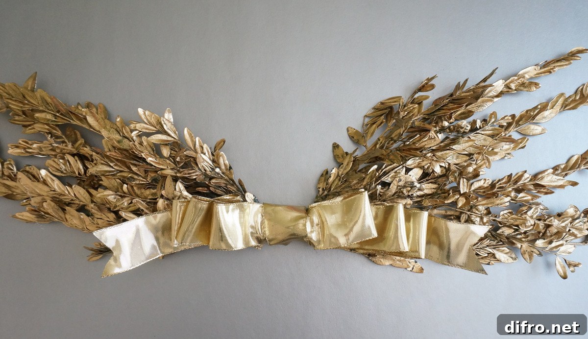 Gold holiday wall hanging with a bow