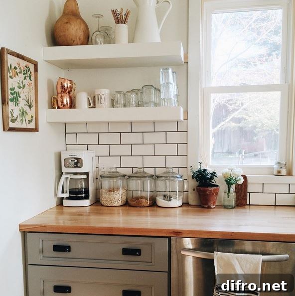 Floating Shelf Ideas to Style Your Living Room 10 Minimalist kitchen that has floating white shelves to hold mugs, cups, and wine glasses.