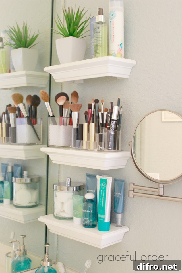 Floating Shelf Ideas to Style Your Living Room 13 Three small white floating shelves in a bathroom that carry makeup brushes and skin care products.