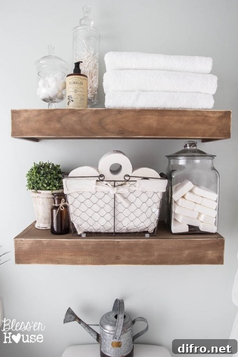 Floating Shelf Ideas to Style Your Living Room 15 Two thick floating shelves made of wood carrying toiletry, soap, and towels.