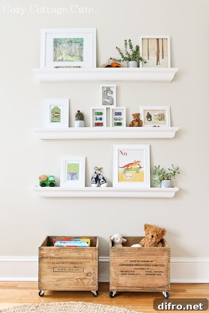 Floating Shelf Ideas to Style Your Living Room 6 Two rolling wooden boxes flanked by three white floating shelves that hold picture frames, planters, and toys.
