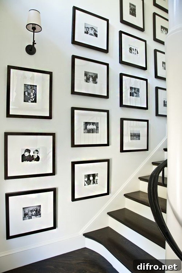 Stairway gallery with black and white pictures in black frames.