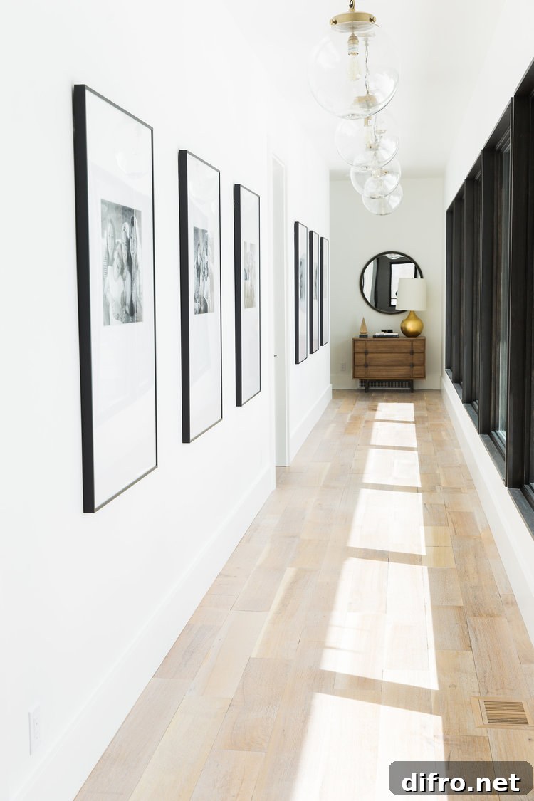 Modern hallway gallery with large black frame pictures.