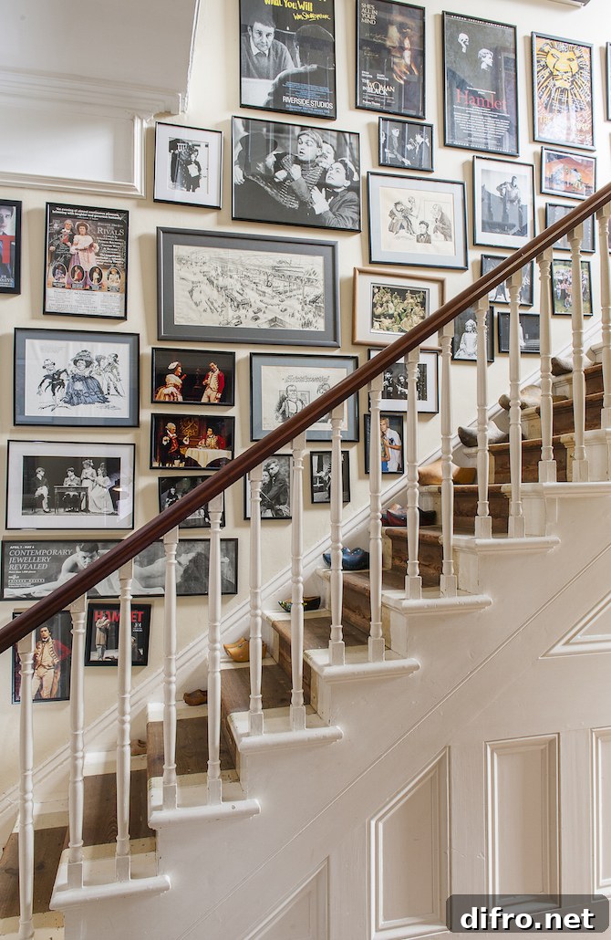 A busy stairway gallery with framed pictures covering almost the entire wall.