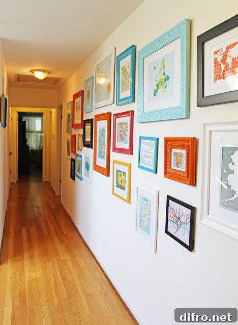 Hallway gallery with colorful frames on a white wall.