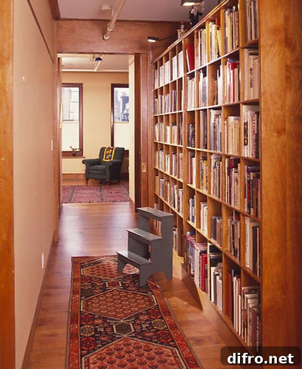 Wooden bookshelf lining a hallway with a red carpet runner.
