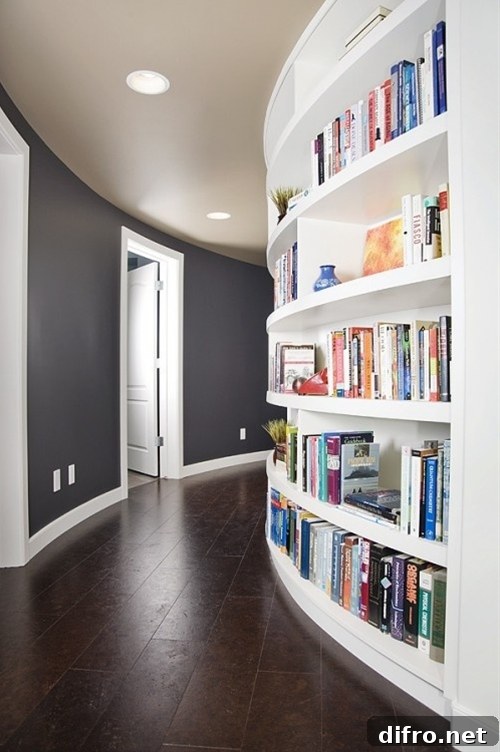 A curved hallway with built-in bookshelf filled with books and decor.