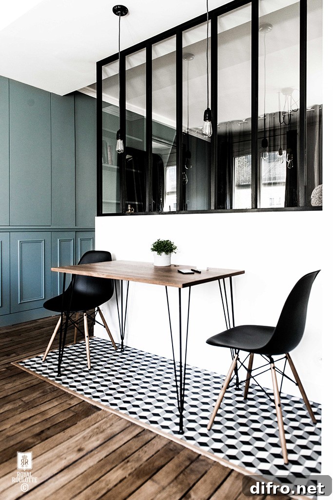 A monochrome kitchen featuring a table and two chairs.