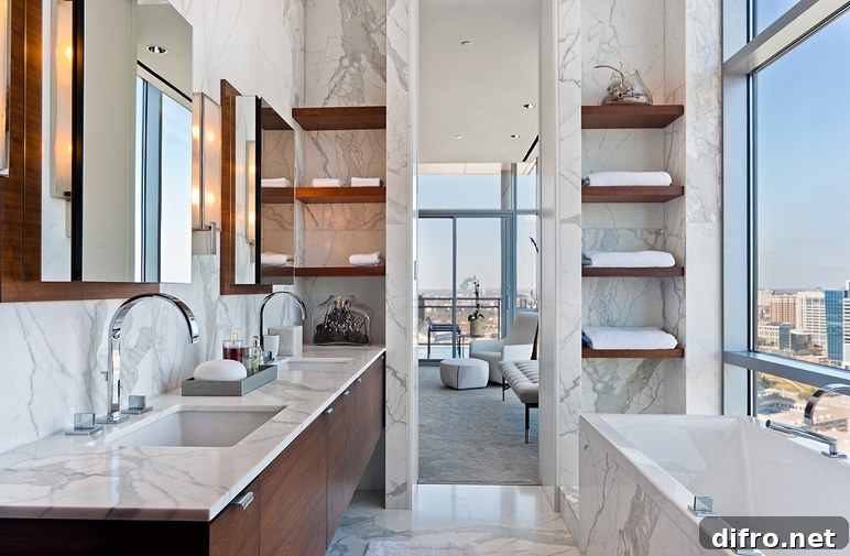 Modern high-rise bathroom design with cherry floating double bathroom cabinets, marble counter tops, marble tiles floor, marble walls backsplash, polished nickel faucets and chunky floating shelves.