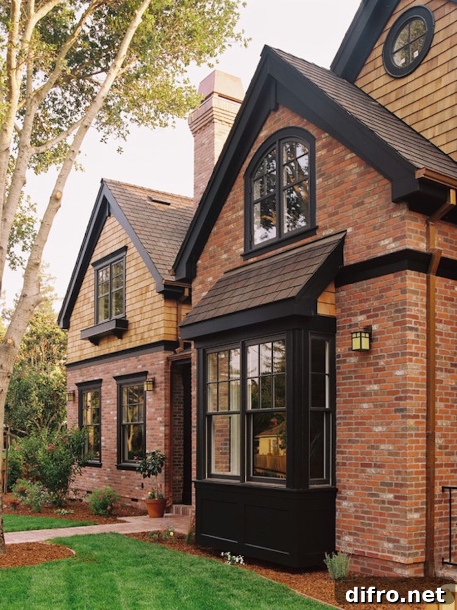 Red brick house with black awnings and trim.