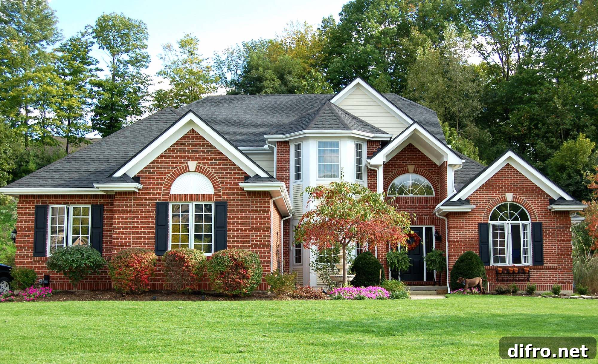 Red brick house with green front grass.