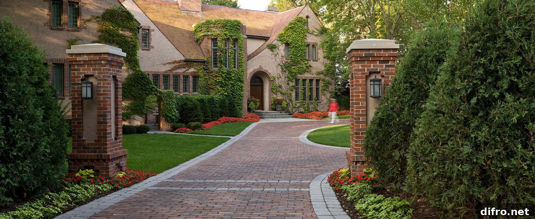 Red brick mansion with matching brick driveway.