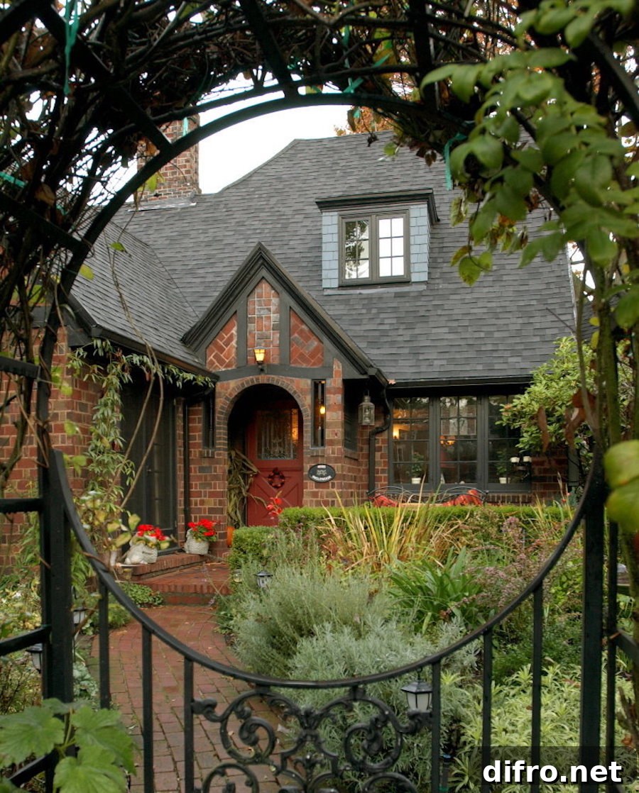Red brick house with black fence that has a circular design.