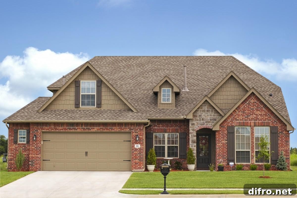 Red brick house with a large two-car garage and concrete driveway.