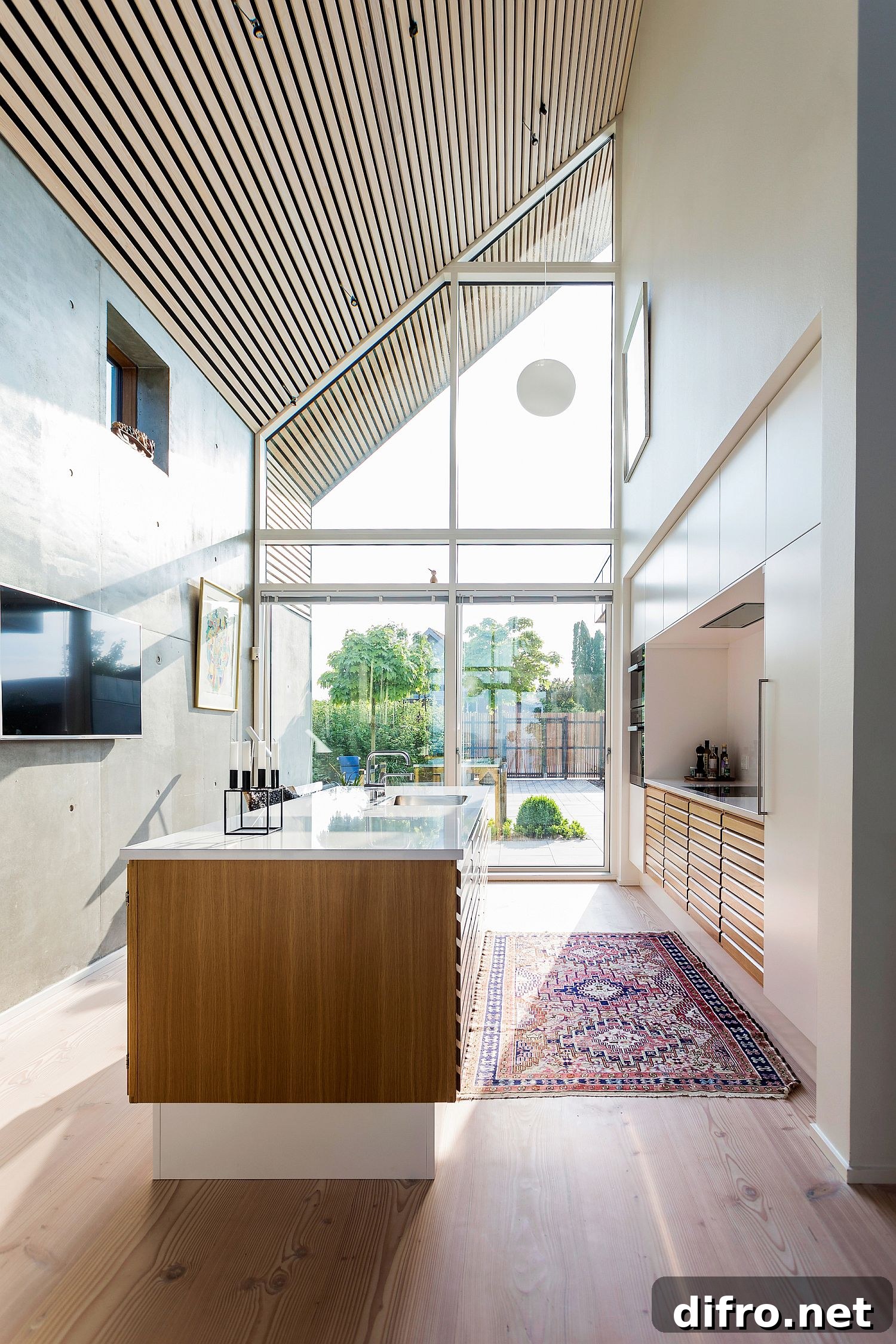 Interior view showing angular roof and large windows at Villa P