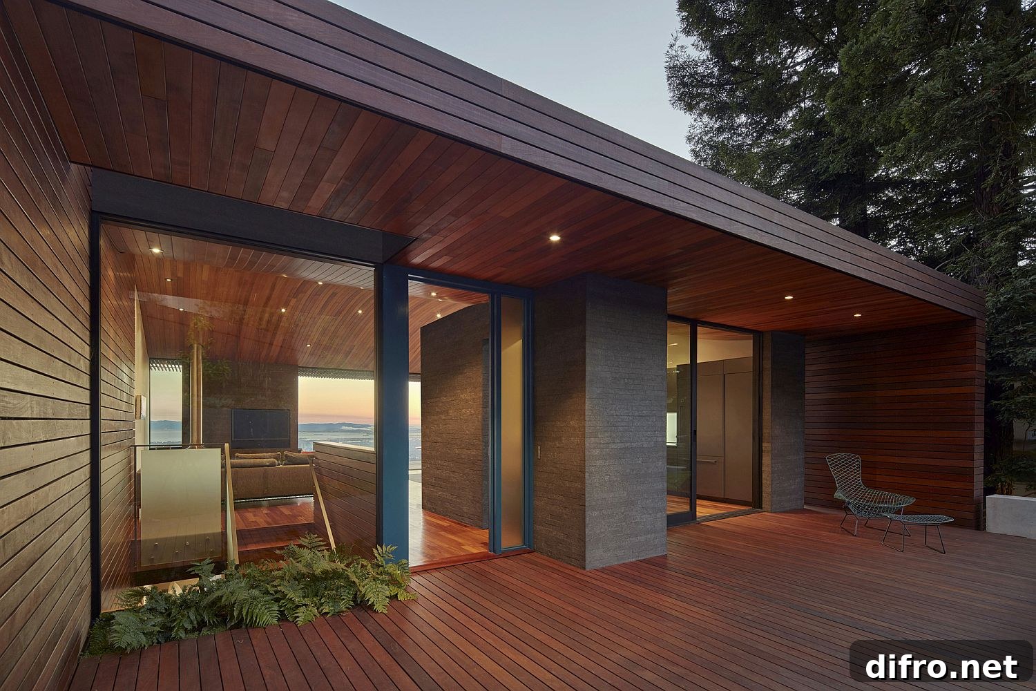 Wooden deck and ceiling add visual warmth to the modern home