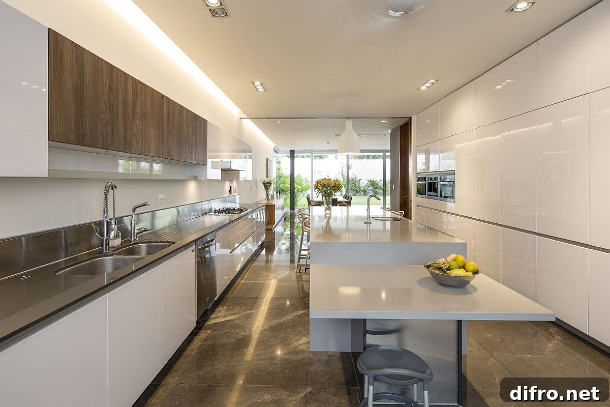 Spacious contemporary kitchen in white with a breakfast bar
