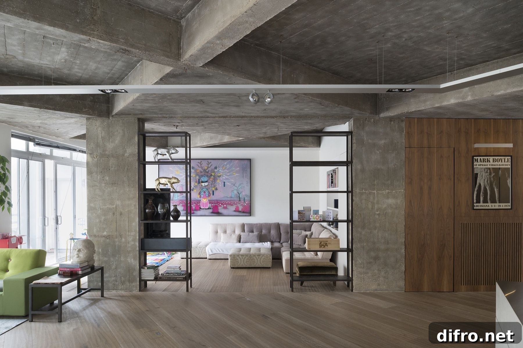 Exposed concrete walls and wooden flooring shape a stylish industrial loft