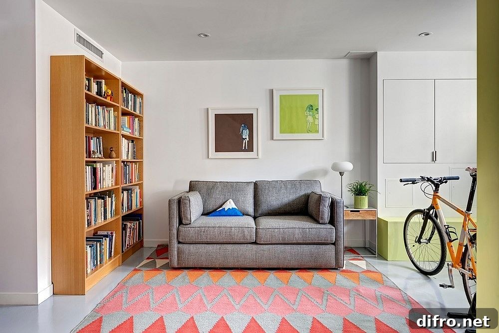 Sitting and media room with gray couch and large bookshelf