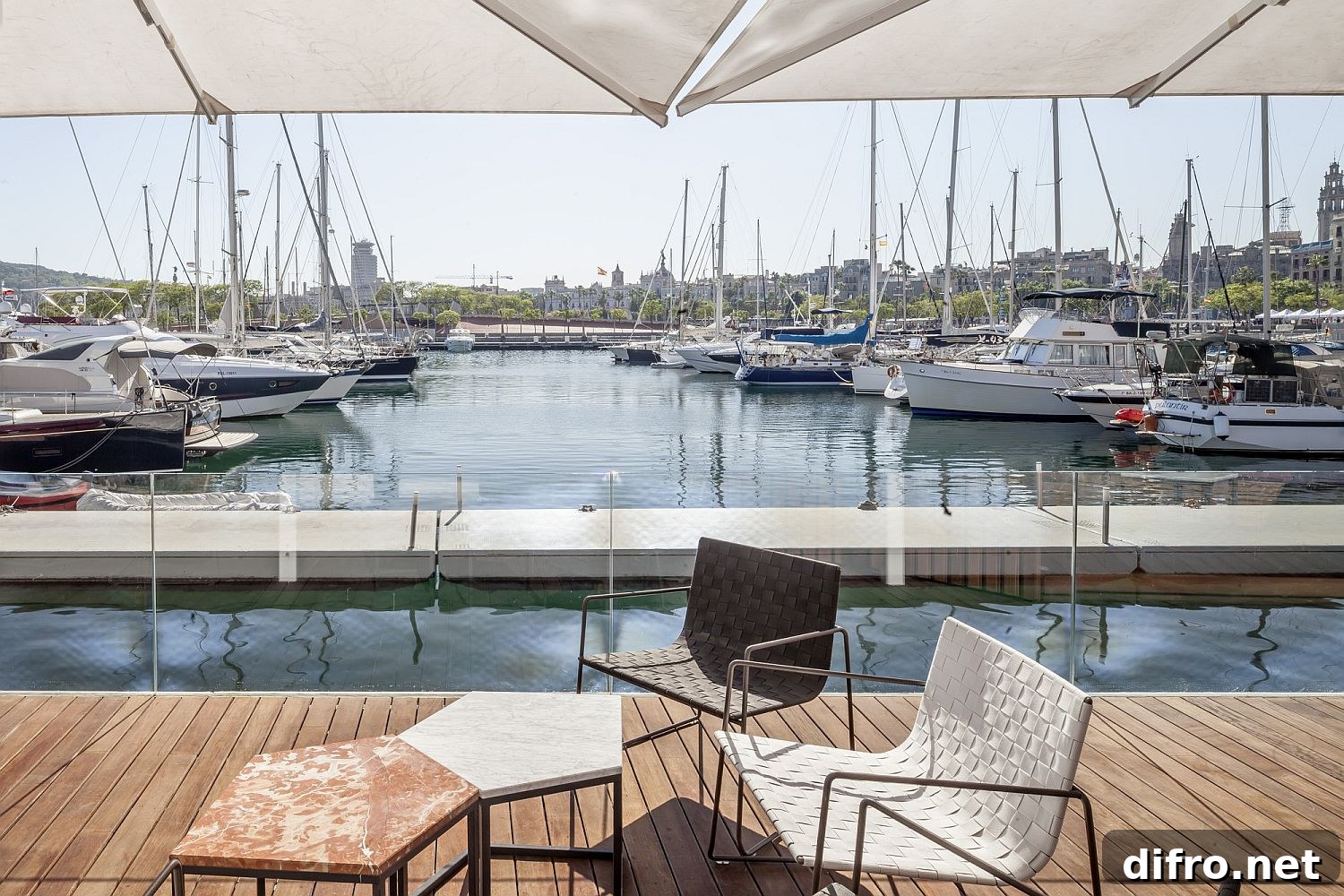 Geo style marble top tables and chic chairs create a wonderful sitting space next to the ocean