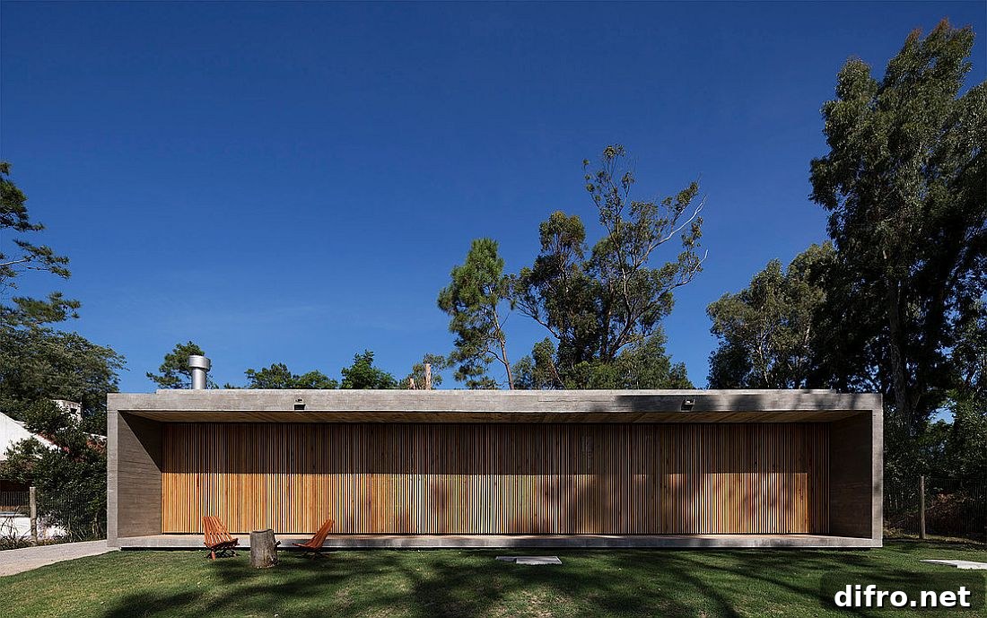 Movable wooden slats create a dynamic facade for the home in Uruguay