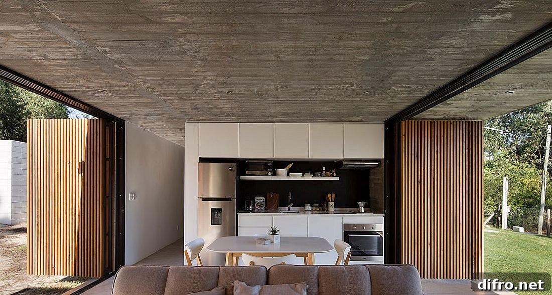 Doors with wooden slats open up to transform the kitchen and living area into a pavilion-style setting