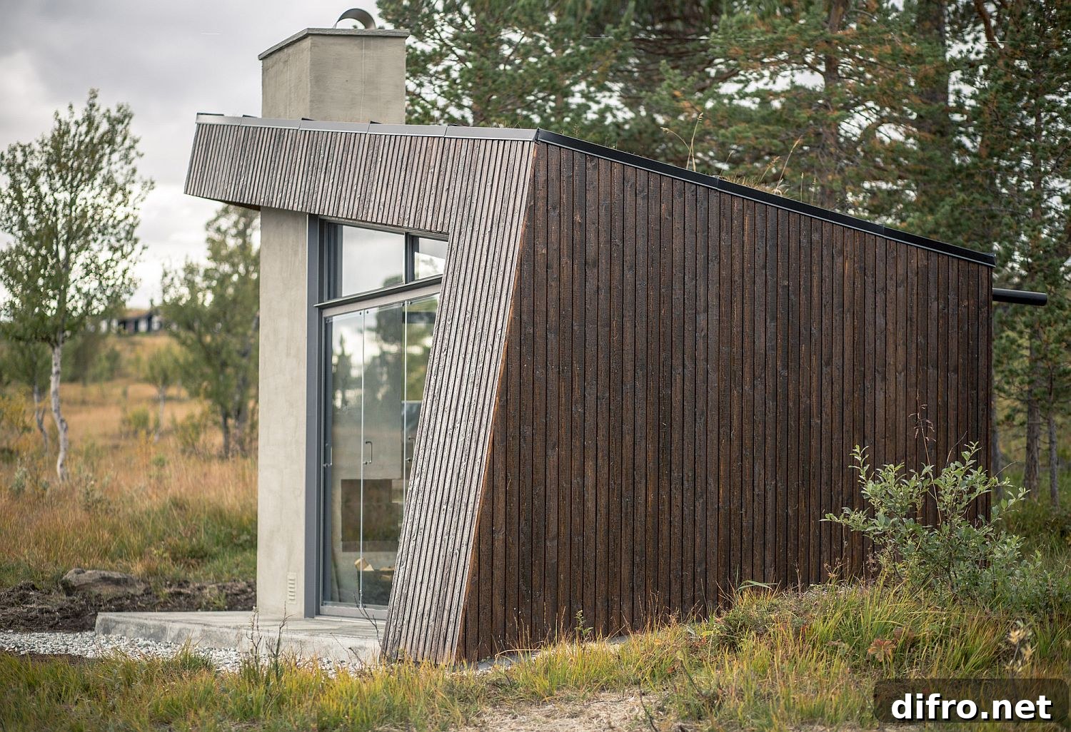 Dark brown stained wood exterior of the cabin in woods